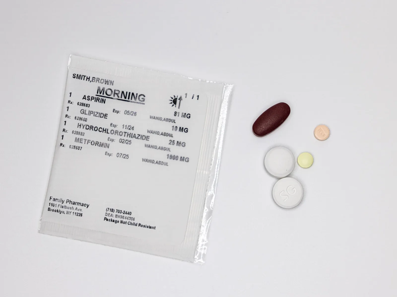 Sealed multi-dose pouch labeled Morning with the patient's medications listed, next to the sorted pills
